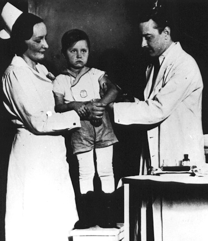 Kolmer injecting son with polio vaccine, 1935