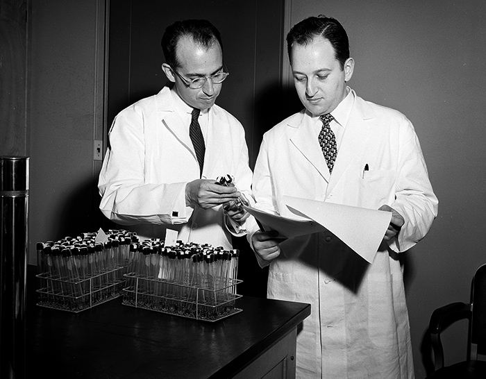 Jonas Salk and Julius Youngner in laboratory, c. 1954